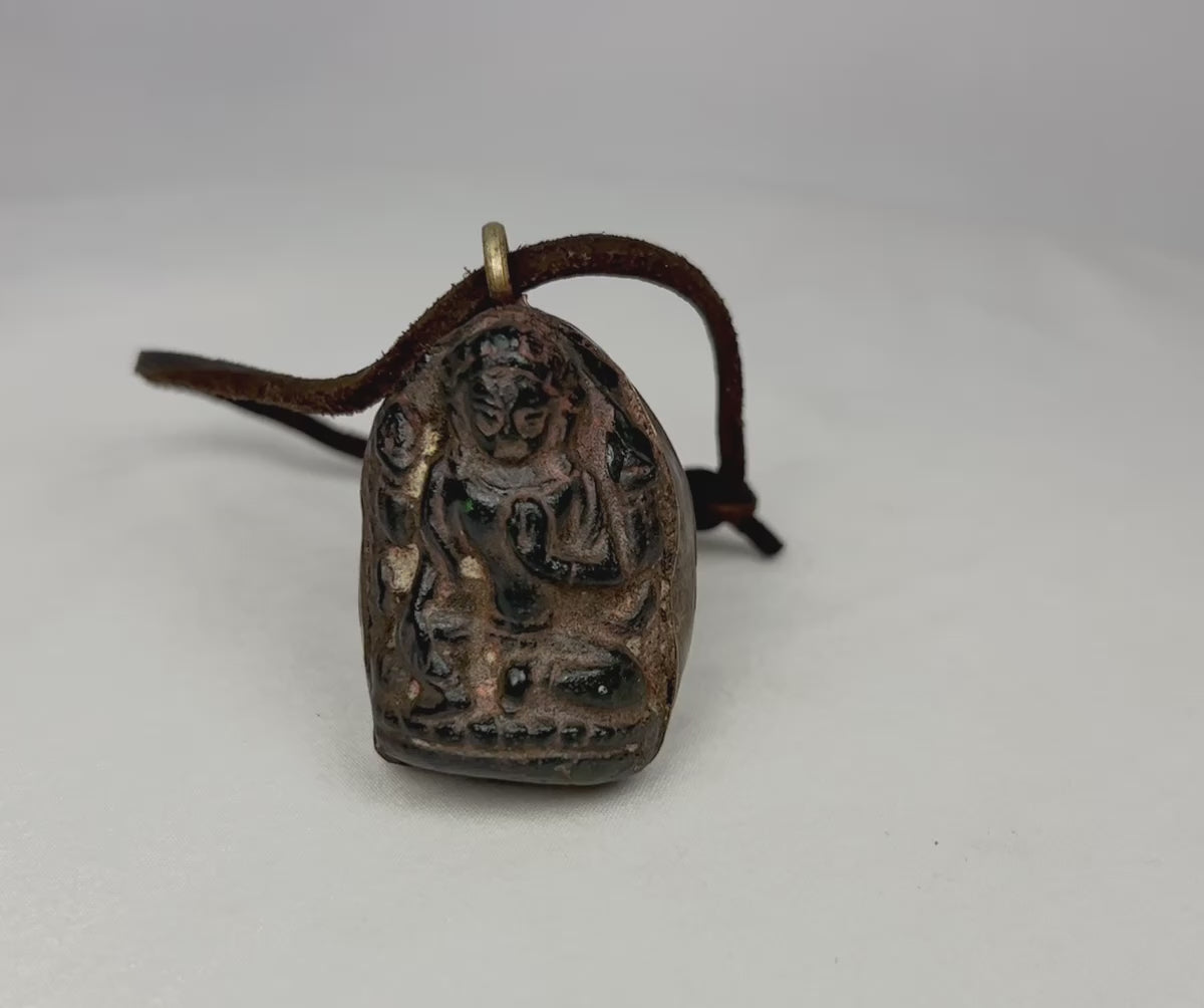 Antique Tibetan/Nepalese bronze Buddha amulet pendant, circa 1880–1920, with shrine-style niche, sealed brass back, original leather cord, and aged patina. Traditional devotional reliquary used for spiritual protection and meditation.