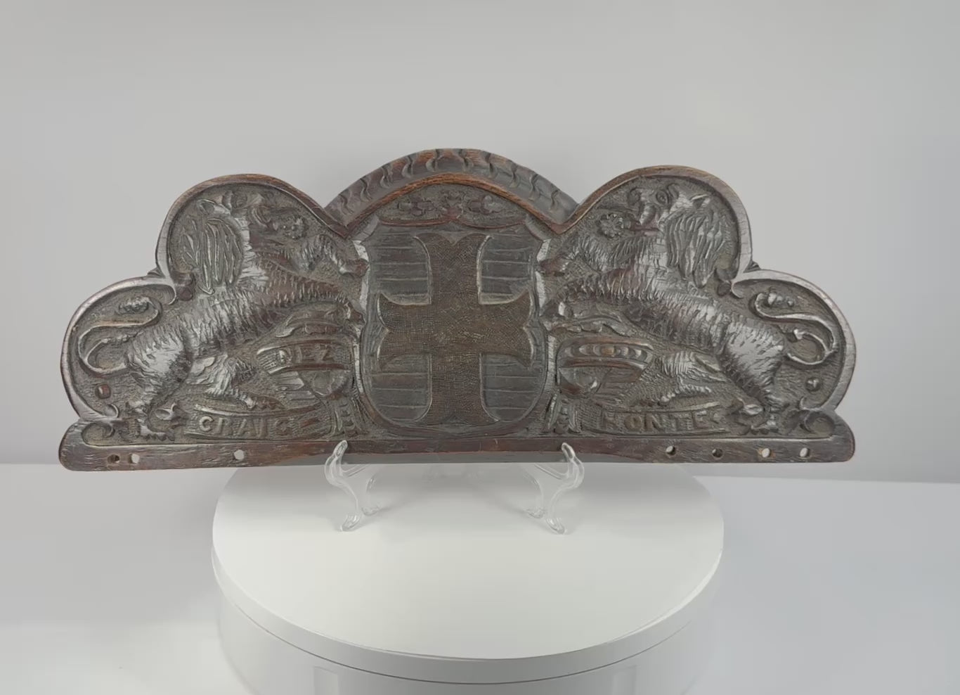 Rotating view of an antique hand-carved oak Bentinck heraldic pediment featuring a cross moline, paired lions, and the motto Craignez Honte