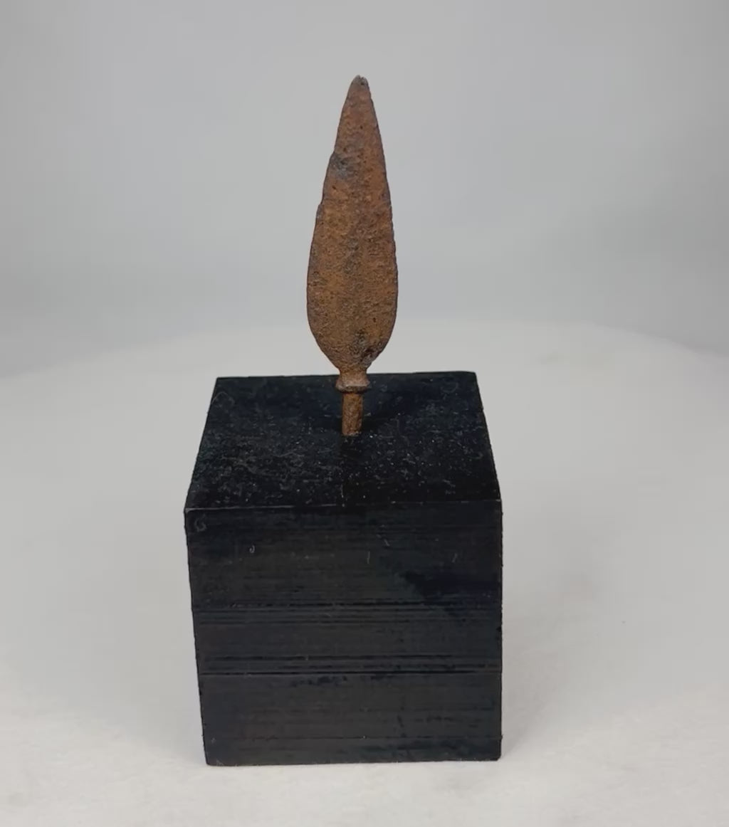 360-degree rotating view of ancient European iron arrowhead relic on display stand