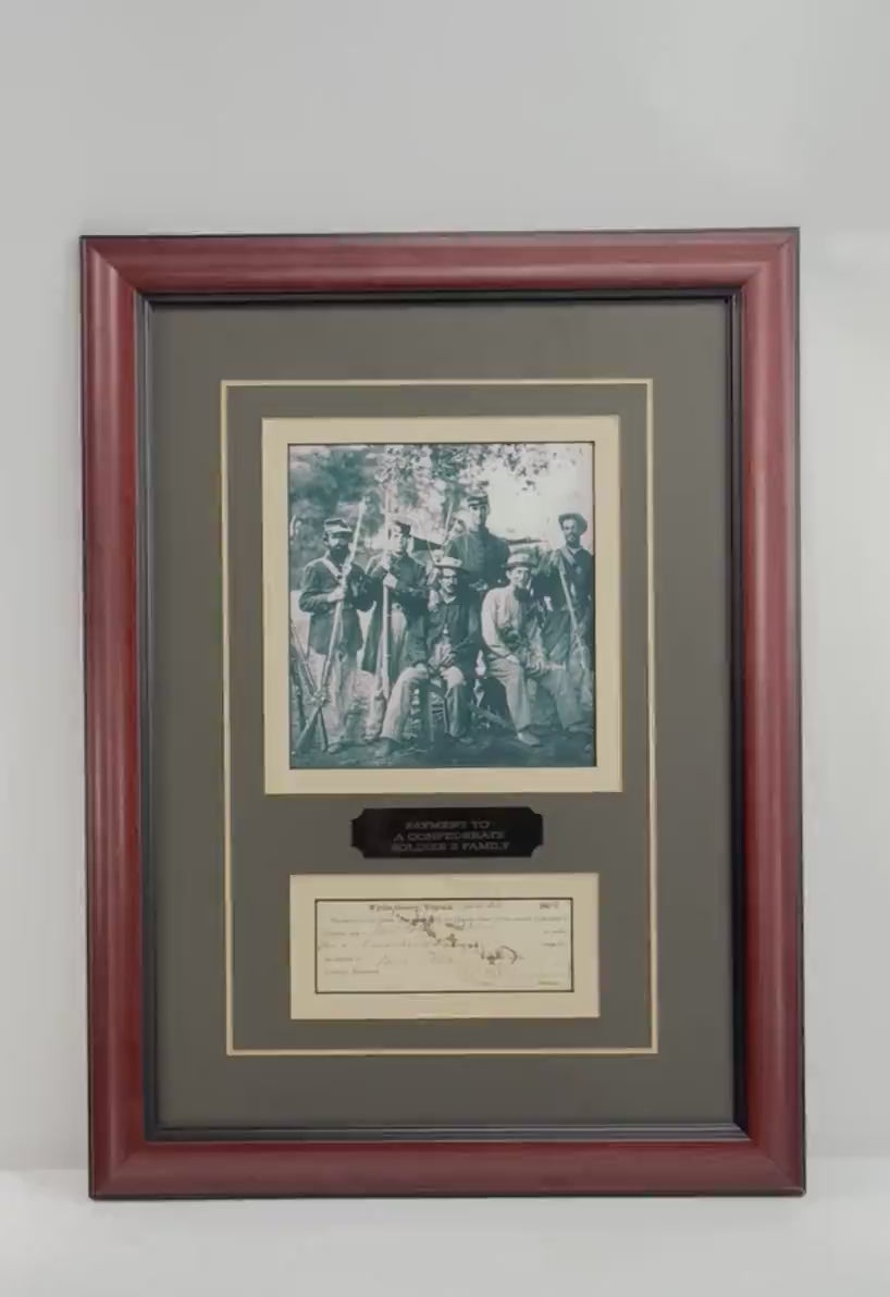 Video showcasing an original 1864 Confederate Civil War soldier's family relief payment voucher from Wythe County, Virginia, professionally framed alongside a historical photograph of armed Civil War-era men. The display features handwritten period inscriptions, decorative matting, an engraved identification plaque, and an accompanying Wall Street Creations Certificate of Authenticity.
