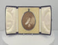 360-degree rotating video of a late Victorian oval sepia portrait of a woman in an elaborate upswept hairstyle, displayed in a black velvet-covered folding presentation case, circa 1895–1915.