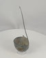 Rotating view of an ancient Roman bronze simpulum ladle with a deep hemispherical bowl, long flat-section curved handle, broad triangular attachment, two raised spur-like projections, incomplete upper terminal, dark blue-green patina, mineral accretions, corrosion, cracks, perforations, edge losses, and archaeological surface wear