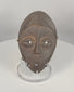 360-degree view of an authentic Lega passport mask carved from wood with dark ritual patina, elongated facial features, and original suspension holes, Democratic Republic of the Congo, mid-20th century.