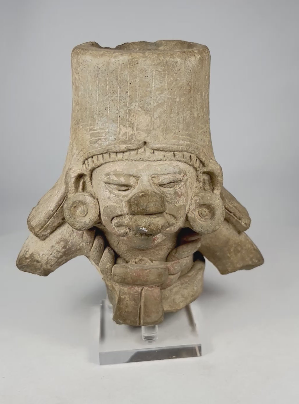 Rotating view of an ancient Pre-Columbian West Mexican terracotta ceremonial head fragment, showing tall headdress, hollow form, ear ornaments, sculptural facial features, and burial patina.