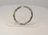 360-degree view of ancient Roman dark glass bracelet with iridescent weathering, mineral deposits, and archaeological patina