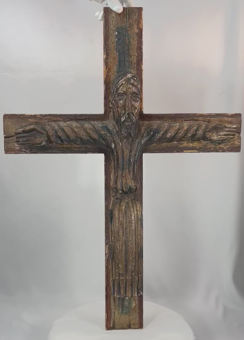 180-degree view of a Spanish Colonial carved wooden crucifix depicting Christ with traces of original polychrome paint.