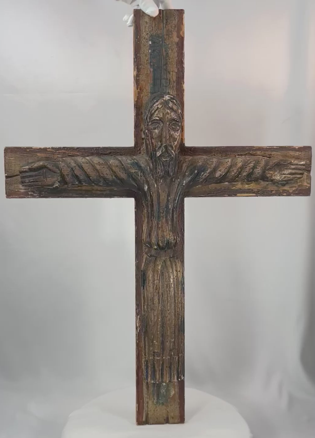 180-degree view of a Spanish Colonial carved wooden crucifix depicting Christ with traces of original polychrome paint.