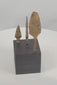 Rotating view of three ancient Roman to medieval hand-forged iron projectile points, including a broad leaf-shaped head, a narrow bodkin-style point, and a compact triangular arrowhead, each with surviving tangs, heavy oxidation, mineral encrustation, and individual black display bases