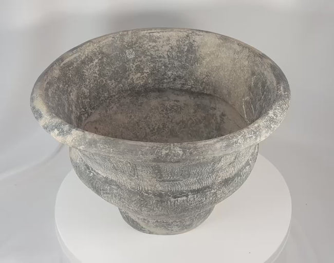 360-degree view of a large Ban Chiang-style earthenware pottery vessel featuring incised geometric decoration, a broad flared rim, textured surface treatment, and an aged archaeological appearance.