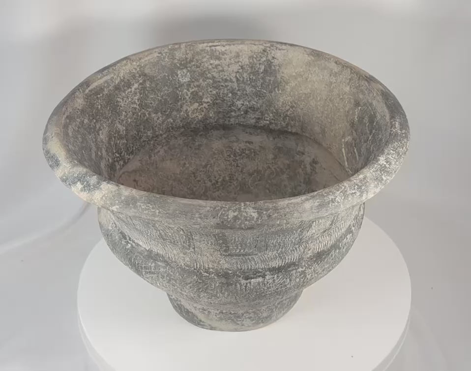 360-degree view of a large Ban Chiang-style earthenware pottery vessel featuring incised geometric decoration, a broad flared rim, textured surface treatment, and an aged archaeological appearance.