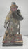 Rotating view of an antique Chinese carved wood statue of Guan Yu with a red-painted face, long natural-fibre or horsehair beard, elaborate polychrome armour, gilt details, dragon decoration, missing weapon, and integral base