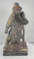Rotating view of an antique Chinese carved wood statue of Guan Yu with a red-painted face, long natural-fibre or horsehair beard, elaborate polychrome armour, gilt details, dragon decoration, missing weapon, and integral base