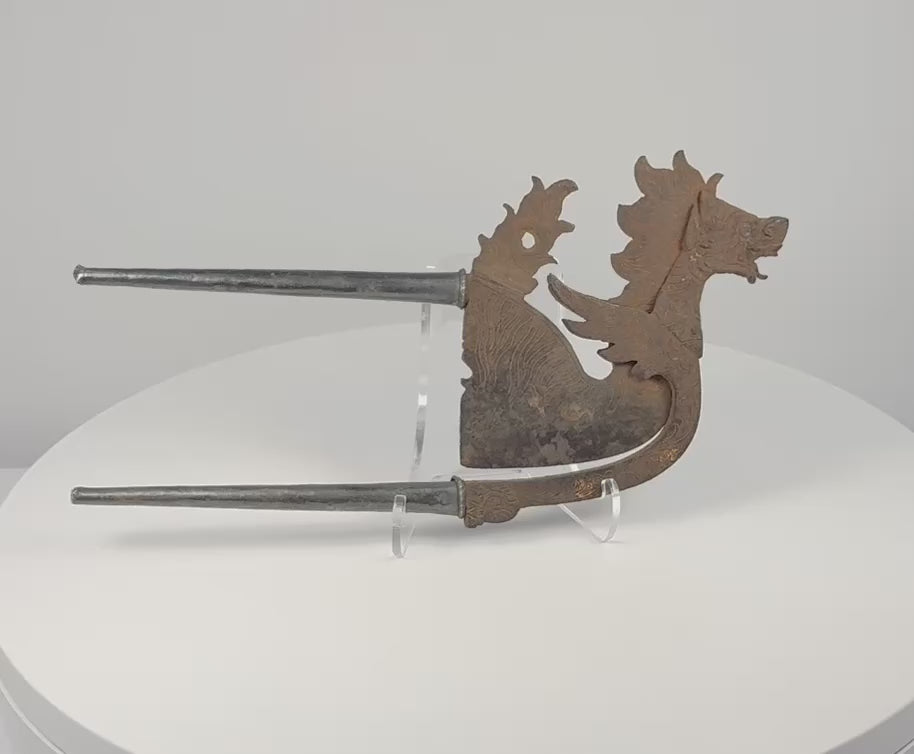 Indonesian dragon-lion betel nut cutter showing sculpted mythical creature form, decorated blade and silver-covered handles
