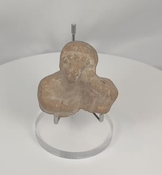 360-degree video of an ancient Classical Mediterranean terracotta figural bust fragment showcasing its mold-made construction, stylized facial features, archaeological patina, and Hellenistic to Roman craftsmanship.
