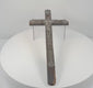 360-degree rotating view of an antique 18th-century French peddler’s crucifix featuring an embossed lead Corpus Christi figure, intricate Arma Christi Passion symbols, decorative religious motifs, and a dark-painted pine wooden cross. Shows the detailed metalwork, aged surfaces, and original hanging loop on the reverse.