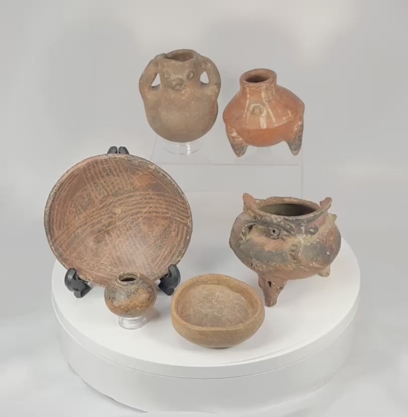 360 rotating video of Pre-Columbian ceramic artifact collection showing effigy vessels, tripod bowl, painted pottery, and surface patina details