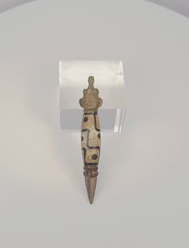 Video showing Tibetan Dzi-style phurba amulet from multiple angles with close-up details of bead, face and blade