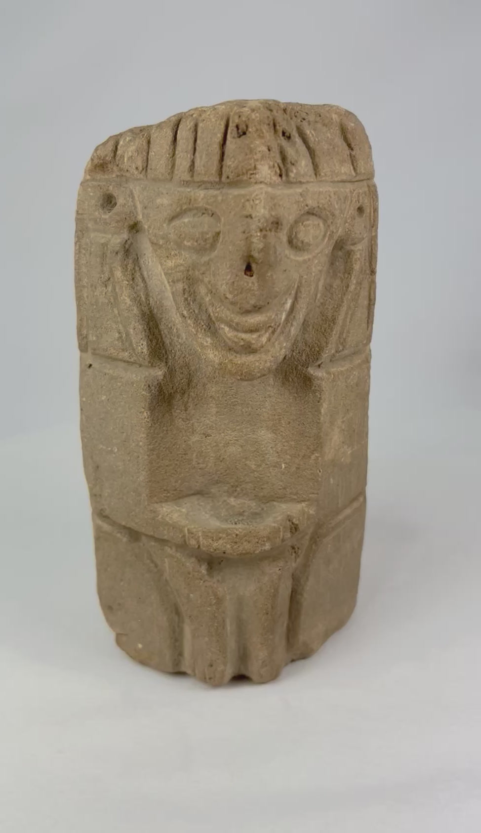 Pre-Columbian carved stone idol from West Mexico or Andean Highlands, circa 500–1000 CE, hand-carved volcanic stone or sandstone, stylized anthropomorphic features with almond-shaped eyes and geometric body, compact ritual or domestic shrine figure