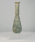 360-degree rotating view of an ancient Roman green glass unguentarium perfume bottle, circa 1st–4th century CE, featuring a pear-shaped body, elongated cylindrical neck, flared rim, and extensive earthy mineral encrustations across its olive-green glass surface.