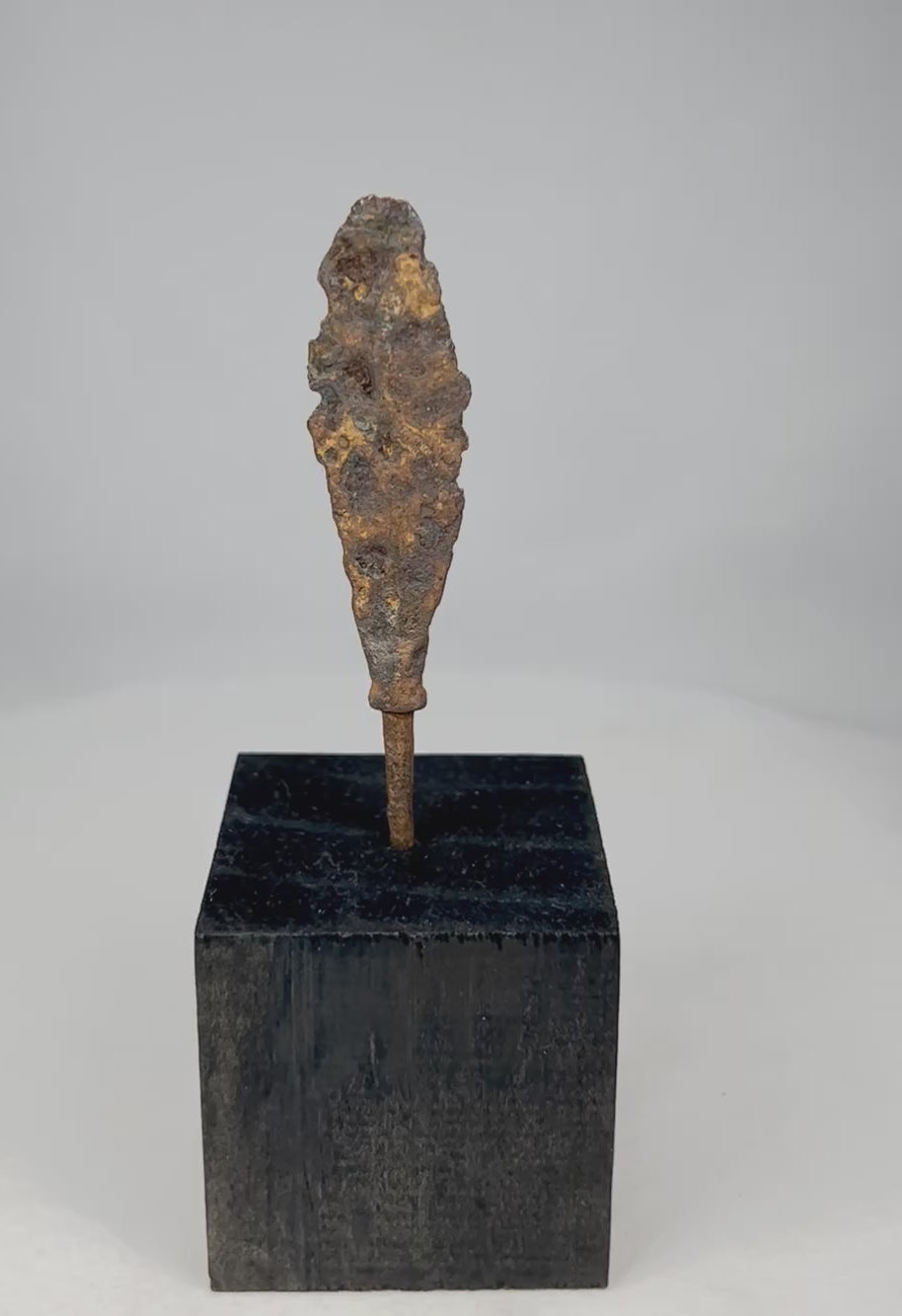 360-degree rotating view of an ancient forged iron arrowhead mounted on display stand