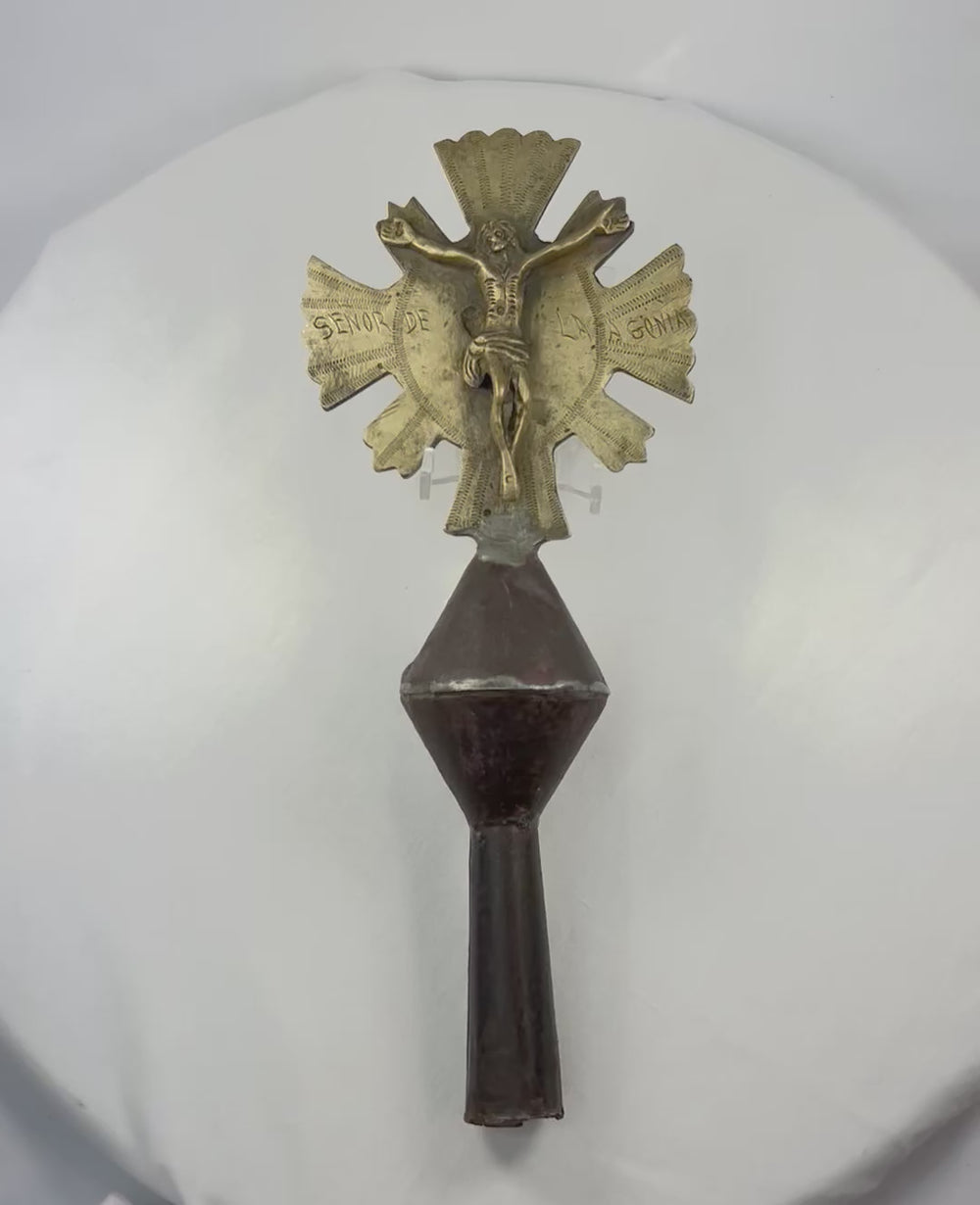 Double-sided Spanish Colonial processional cross finial in cast and engraved brass with iron shaft, featuring Christ on the cross with sunburst rays on one side and a saint holding a fish on the reverse, Latin America (Peru or Bolivia), 18th–19th century