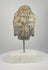 Video showing multiple angles of an 18th–19th century Southeast Asian carved stone Buddha head with curled hair, traces of pigment and a modern marble display base