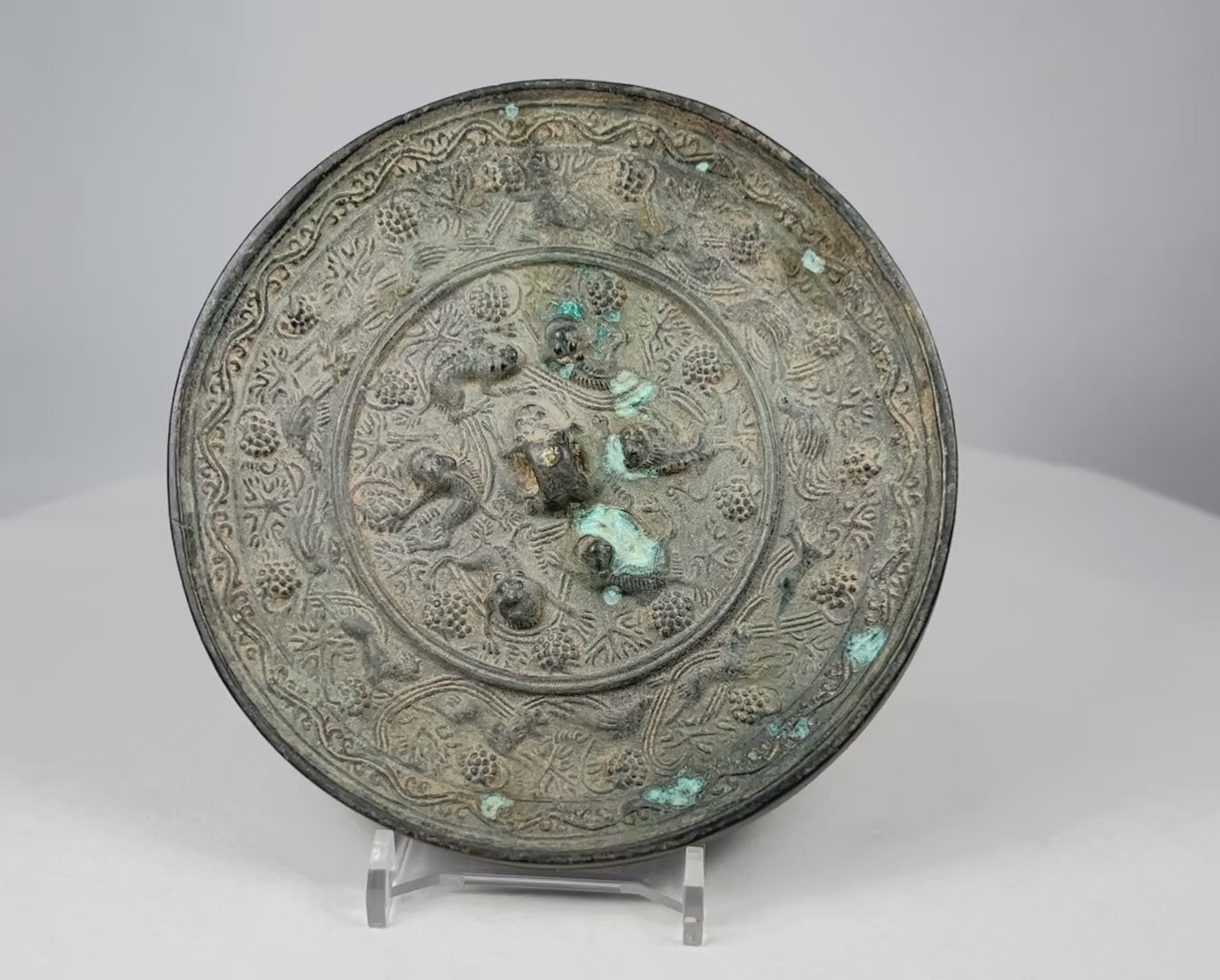 360-degree view of antique Chinese Tang style bronze mirror with sea creature motifs and natural patina