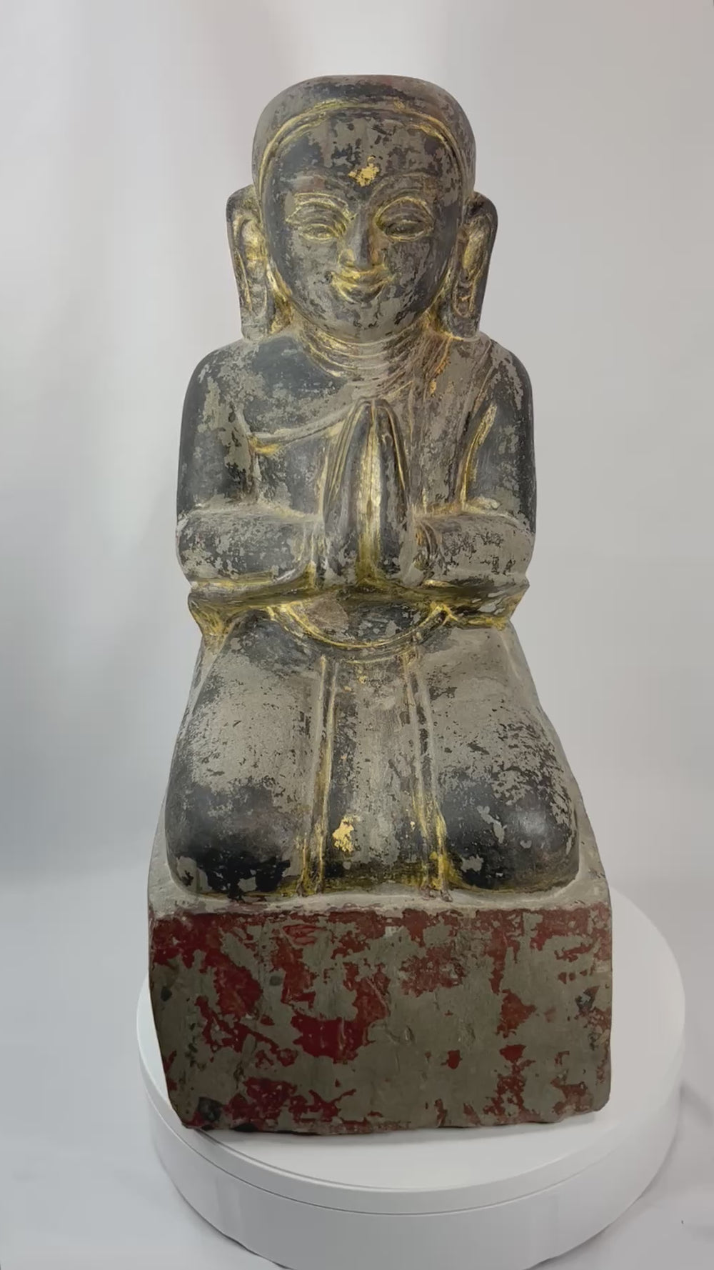 360-degree view of a Burmese Mandalay period carved wooden sculpture of a kneeling Buddhist devotee with hands in prayer and traces of original parcel gilding.