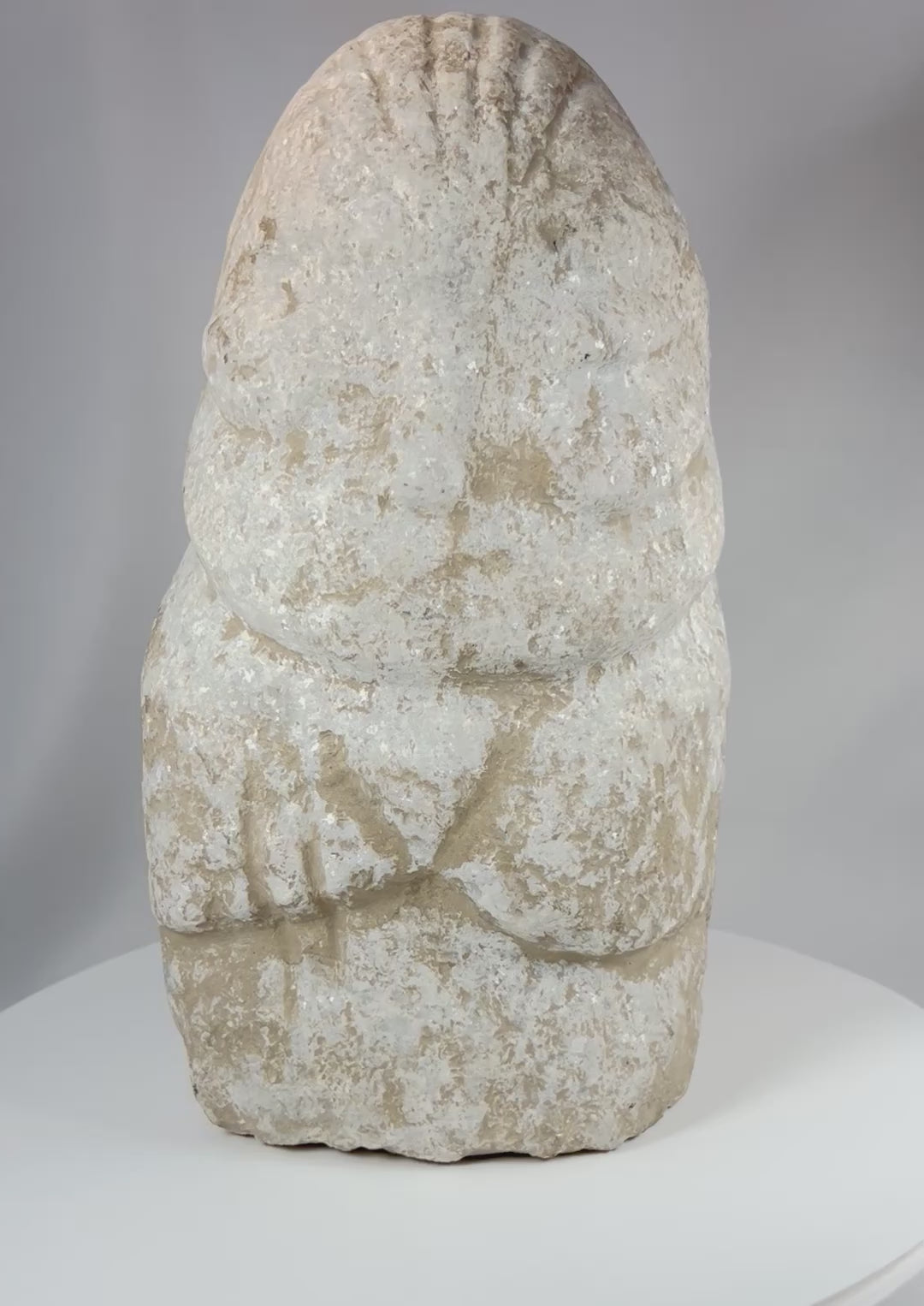 Ancient Near Eastern limestone anthropomorphic idol rotating view showing surface texture and carved form
