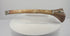 Rotating presentation of antique Tibetan Buddhist kangling human femur bone ritual trumpet with carved dragon motifs and metal fittings