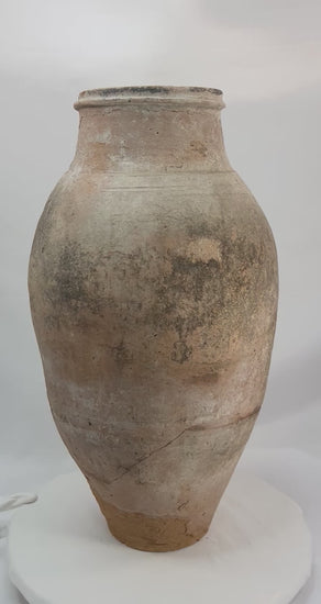360-degree view of an authentic Late Byzantine terracotta storage vessel showing its olive-shaped body, worn maritime patina, and visible ancient repair across the midsection, highlighting its archaeological authenticity and historical trade significance.