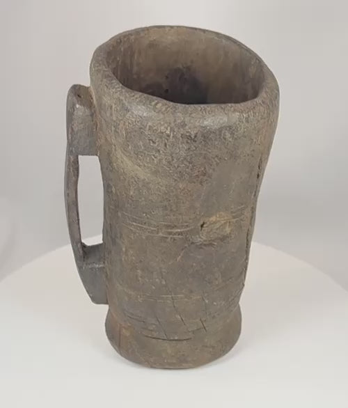 360-degree view of an antique Himalayan hand-carved wooden vessel with integral handle, aged patina, shrinkage cracks, and rustic ethnographic character