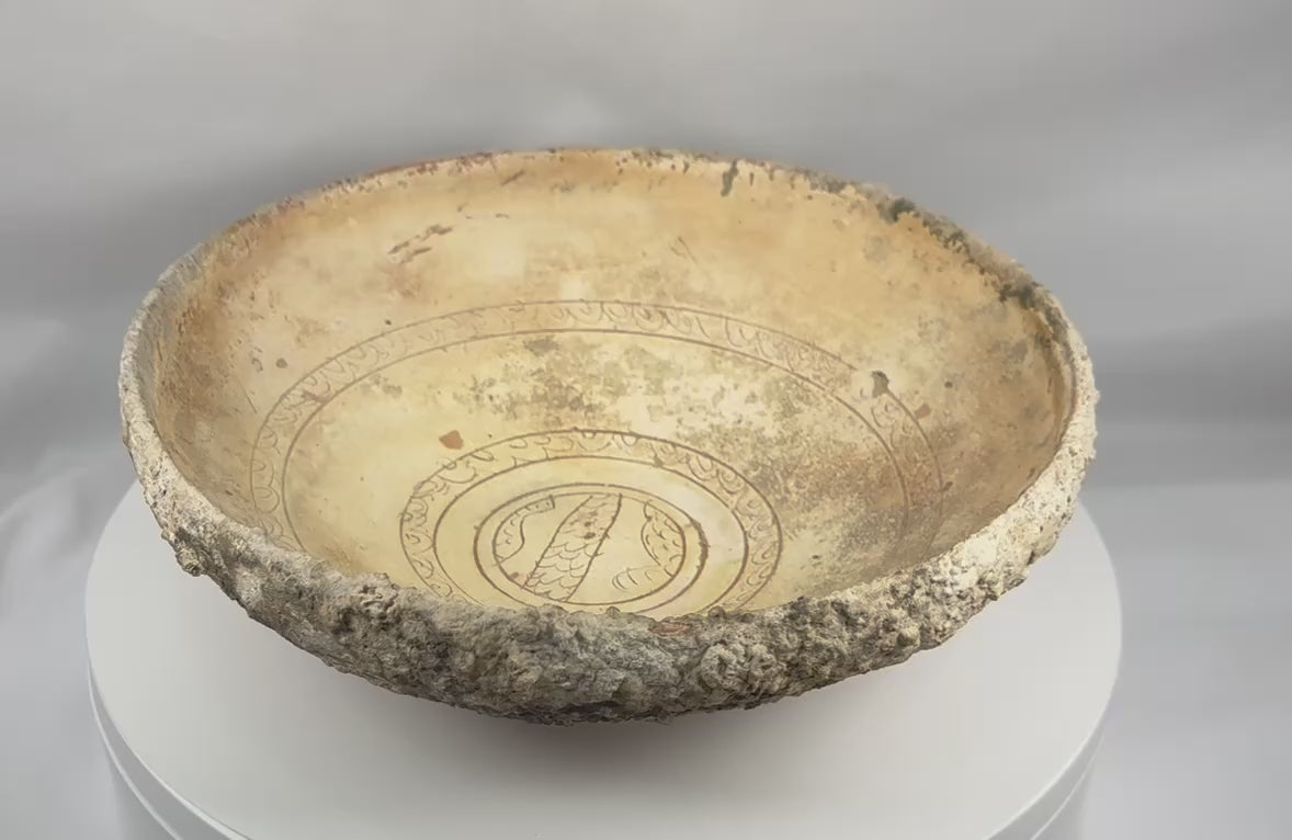 360-degree video of an authentic Byzantine sgraffito slipware bowl showcasing its incised concentric decoration, cream slip glaze, marine encrustations, archaeological patina, and medieval Eastern Mediterranean craftsmanship.