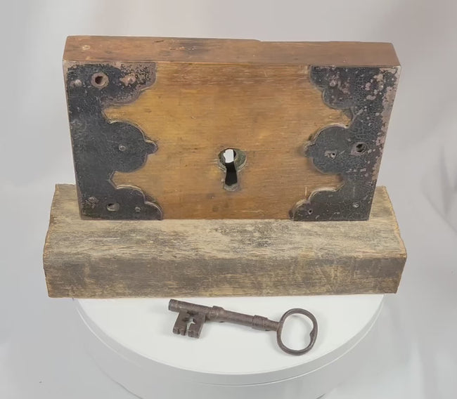 Video showing rotating view of early 19th century wooden rim lock with iron fittings skeleton key and aged patina