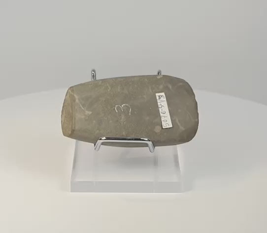 360-degree rotating view of a Pre-Columbian Andean ground stone axe from Ecuador or Peru, circa 200–800 AD, showing its profile, beveled cutting edge, surface wear, and archaeological markings.