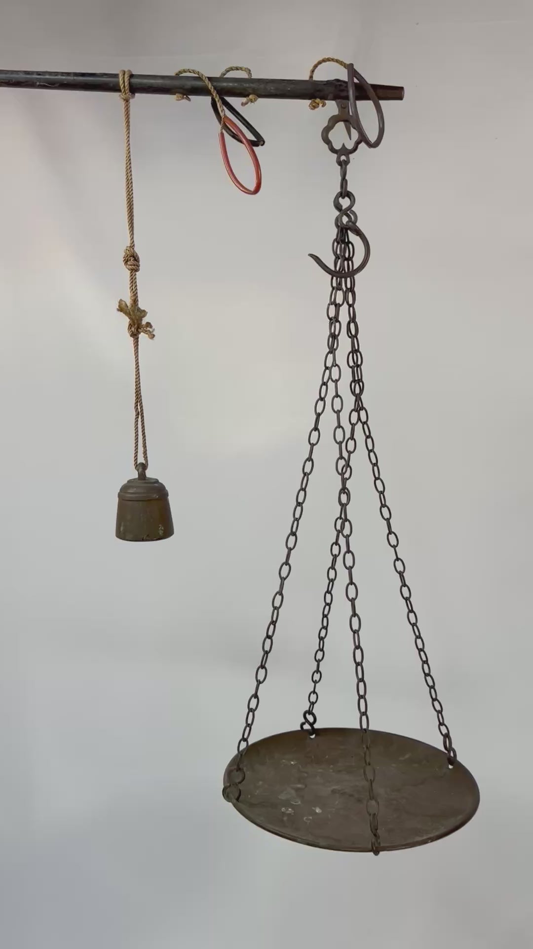 Antique Indian steelyard balance scale, circa 18th–19th century, with forged iron beam, engraved calibration notches, bronze hanging pan, and original cast bronze weight with woven cord. Traditional Mughal/Colonial trade tool with rich aged patina.