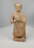 Rotating view of primitive terracotta standing male figure with textured surface and stylized features