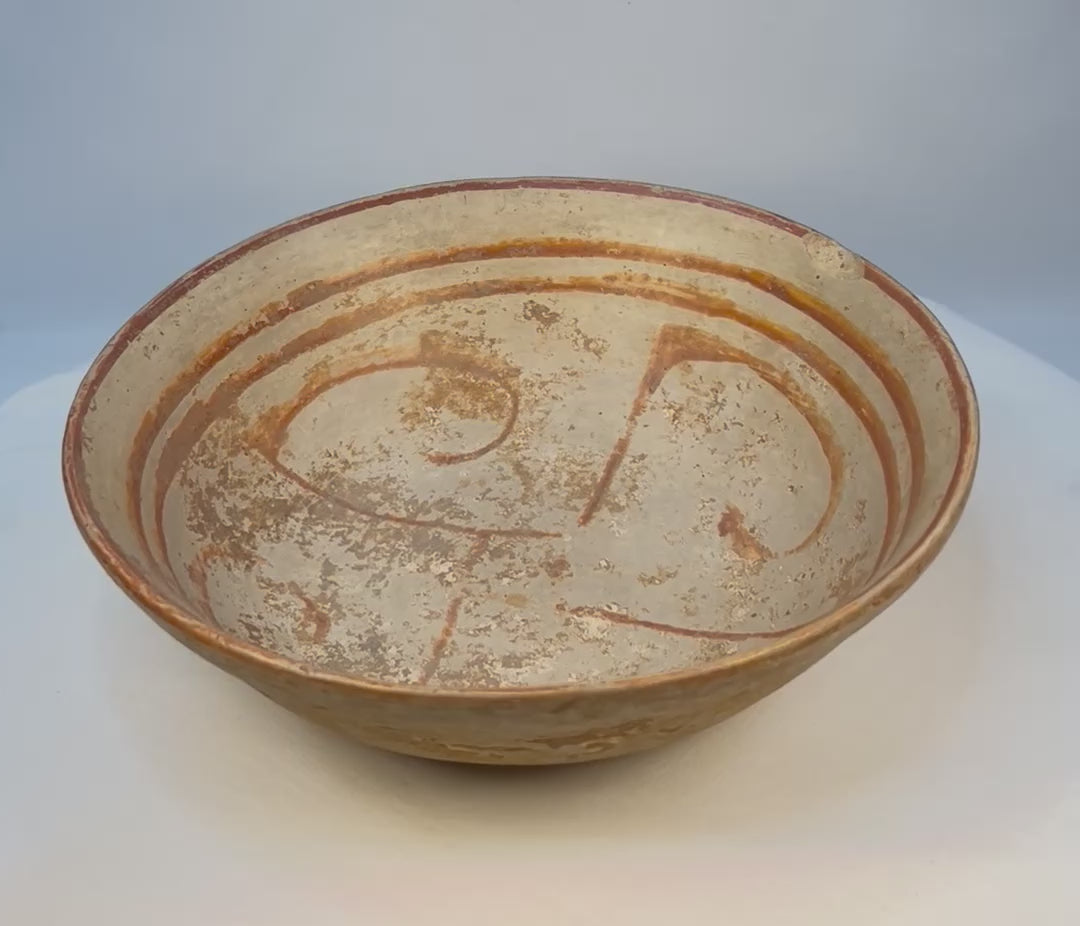 Rotating view of an ancient West Mexican Pre-Columbian terracotta bowl with cream slip and red painted geometric swirl design, circa 300 BCE–300 CE.