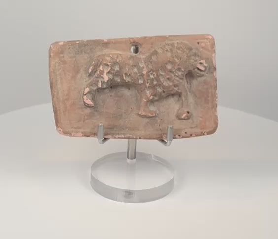 360-degree rotating view of an ancient Indian moulded terracotta feline plaque, showing the raised animal relief, curled tail, suspension hole, aged surface, central crack, and reverse.