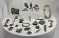 360-degree rotating view of a collection of ancient Roman bronze artifacts including belt fittings, harness mounts, buckles, and decorative metal fragments from the Roman Empire (1st–4th century CE)