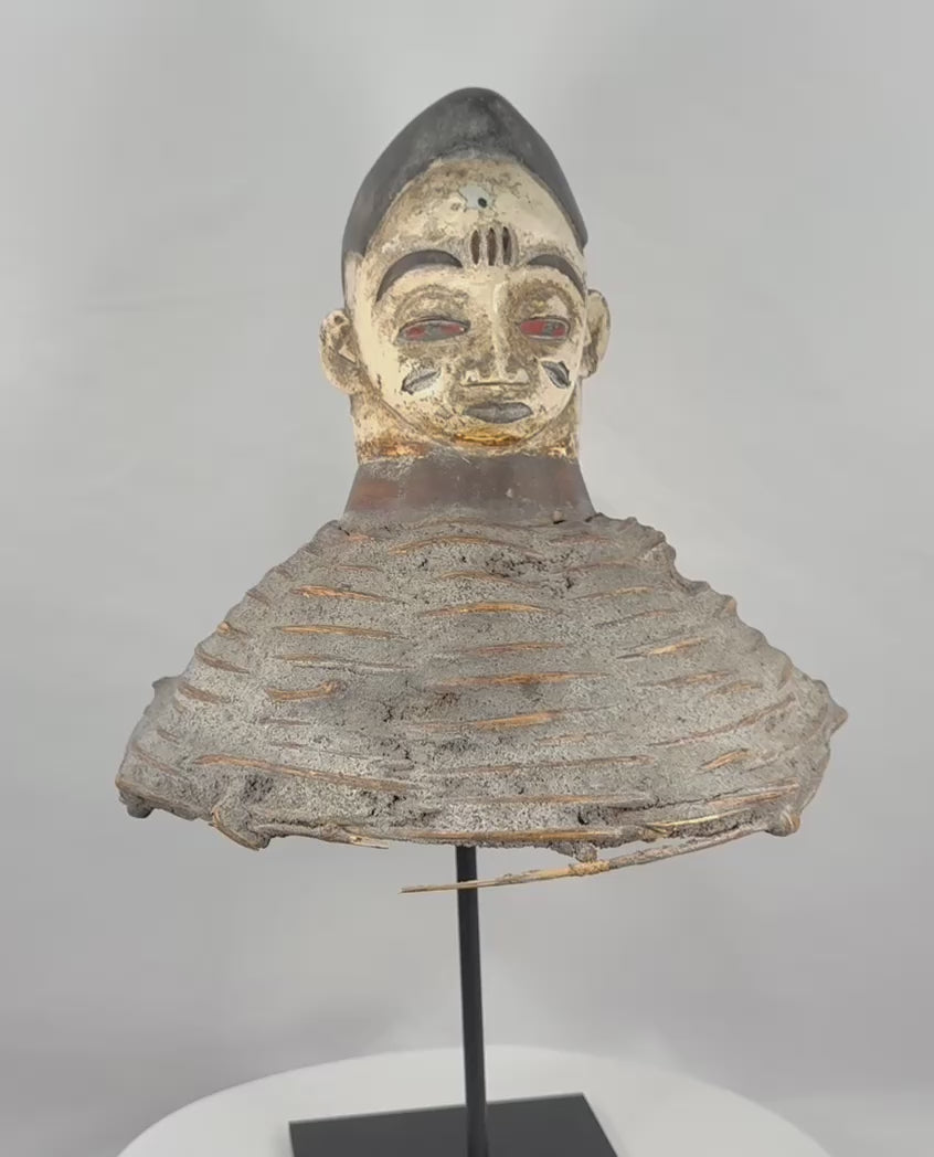 360-degree view of a Yoruba Egungun headdress from Nigeria featuring a carved ancestral face, original painted decoration, woven wicker framework, and evidence of ceremonial use and age.