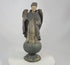 Antique Colonial Latin American polychrome wooden angel or saint figure, 18th–19th century, standing on orb base, gilded wings, remnants of original painted surface, later added sterling silver chain and cross marked 'Sterling, Mexico', traditional folk-religious craftsmanship