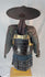 Authentic Japanese samurai armor from the Muromachi Period (1333–1573), featuring black-lacquered cuirass with gold accents, kote sleeves with chainmail reinforcement, dark-blue silk lacing, and a lacquered jingasa war hat bearing the Takeda clan crest, displayed on a wooden stand against a white background
