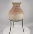 Rotating presentation of a Pre-Columbian Greater Nicoya ceramic vessel with a globular body, flaring rim, cream slip, and surviving red geometric decoration.
