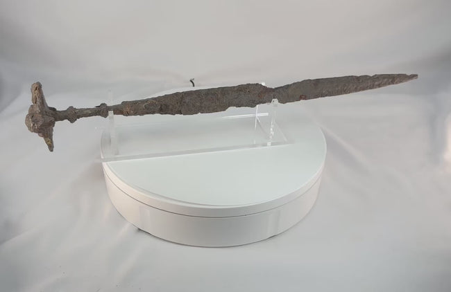 Video showing an ancient Luristan iron short sword from Western Iran, dating to circa 750–650 BCE, with a lion-head disc pommel, ribbed grip, straight double-edged blade, and naturally aged surface oxidation from antiquity.