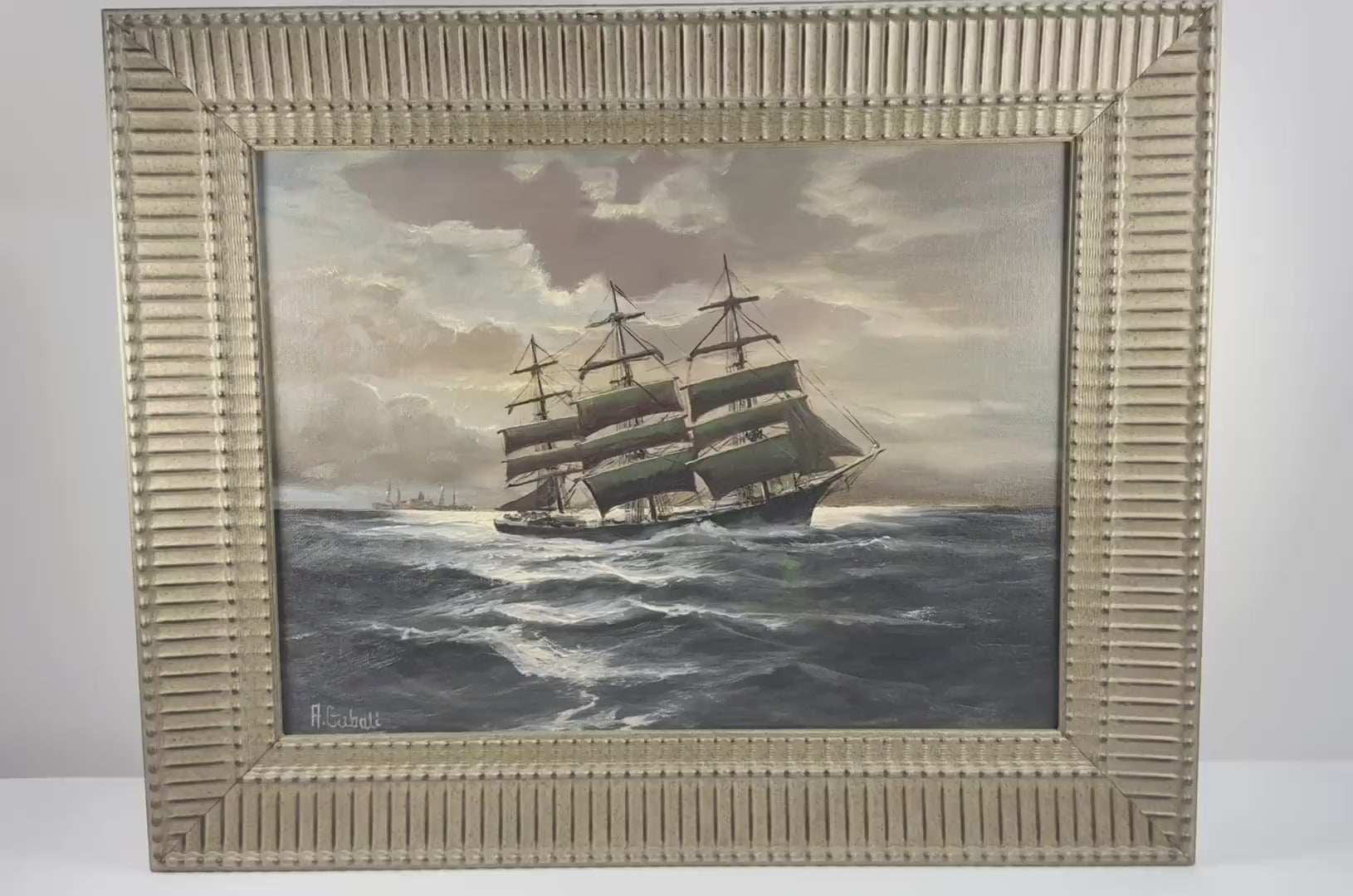 Video of Alfred Gabali’s “Ships That Pass in the Night,” circa 1958, a maritime oil painting depicting sailing ships at sea in an ornate gold-toned frame.