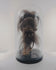 Rotating video of a mid-20th-century Amazonian-style shrunken head replica in a glass globe, showing the stitched animal hide, facial details, horse hair, and complete display presentation.