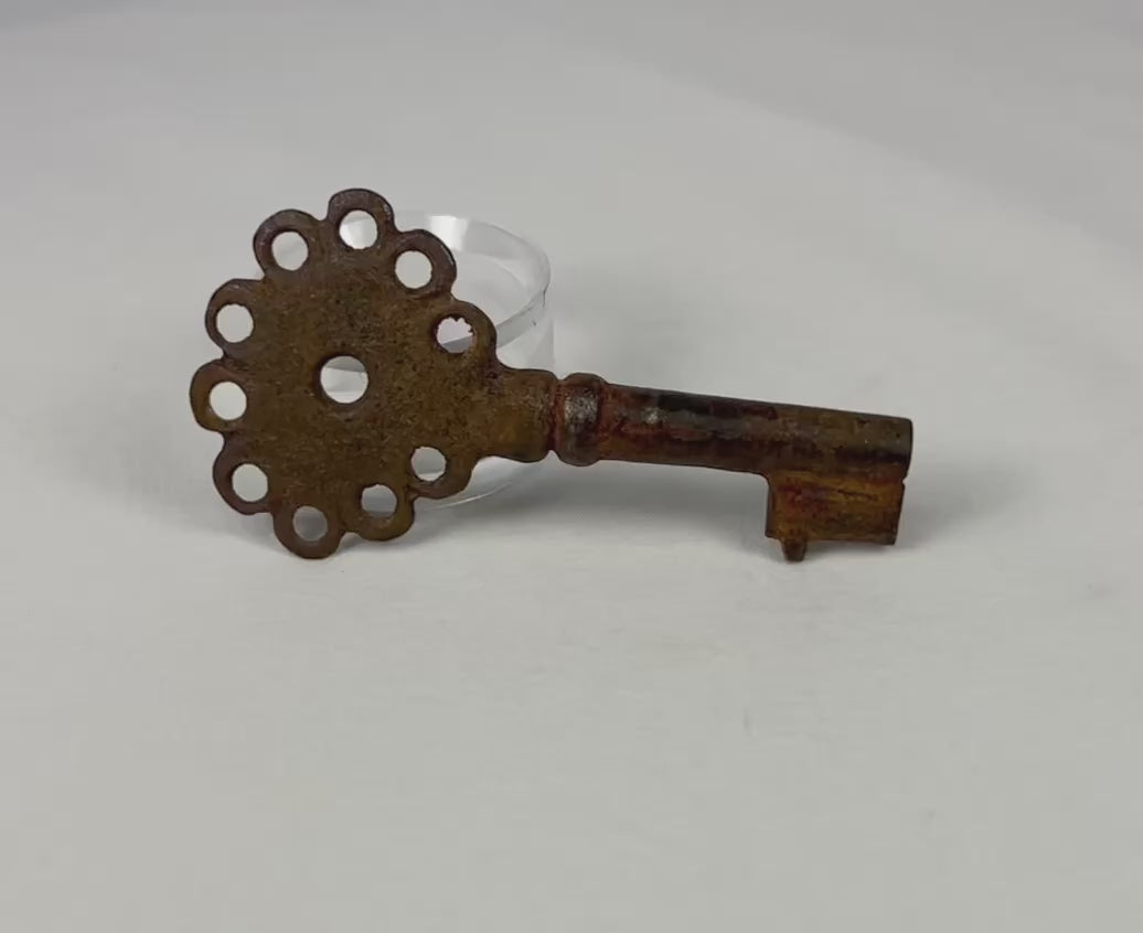 Spanish Colonial iron key, circa 16th–18th century, forged with pierced head and natural oxidation. Compact functional key used for doors, chests, or storage in the Spanish Empire, reflecting colonial craftsmanship, authority, and utilitarian design.
