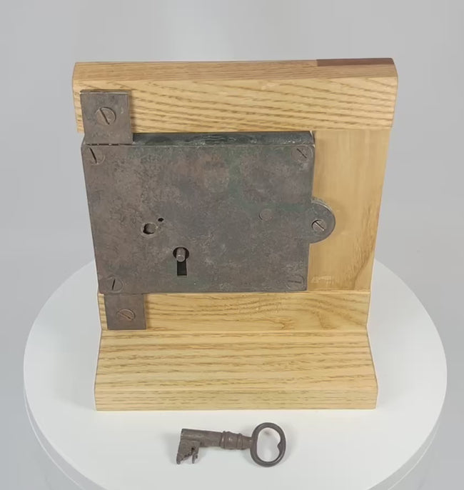 360-degree rotating view of antique iron rim lock with original key showing full structure, patina, and hardware details