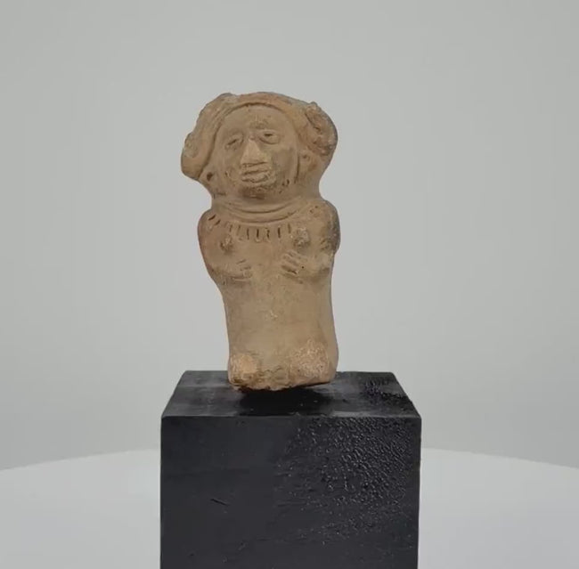 360-degree rotating video of an ancient seated female terracotta figurine from Veracruz, Mexico, circa 600–900 CE, featuring an elaborate headdress, detailed facial features, decorative necklace, and sculpted hands resting on the torso. A Pre-Columbian artifact with natural earthen patina.